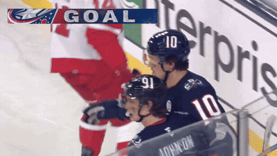 Hockey Player In Number 10 Jersey Next To Another Player GIF
