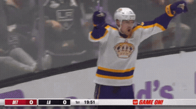 Hockey Player In Purple And Yellow Jersey Celebrates Goal GIF