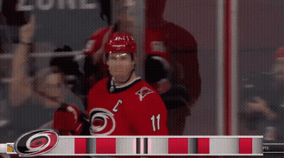 Hockey Player In Red Jersey Number 11 GIF