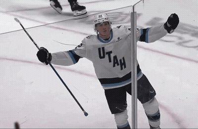 Hockey Player In Utah Jersey Holding Up Arms GIF