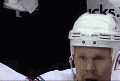 Hockey Player In White Helmet Standing In Locker Room GIF