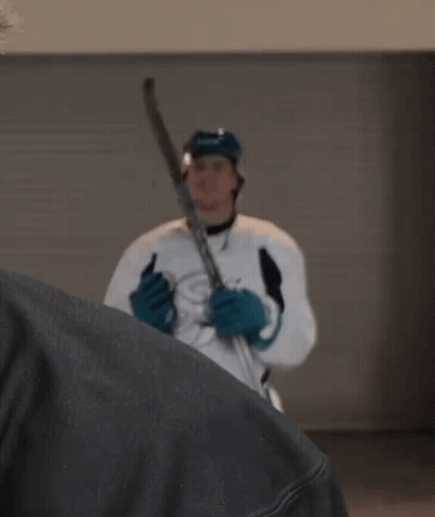 Hockey Player In White Jersey And Blue Gloves Holding Stick GIF