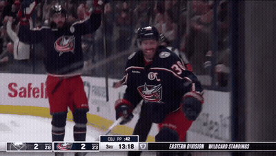 Hockey Player Jumping While Referee Looks On GIF