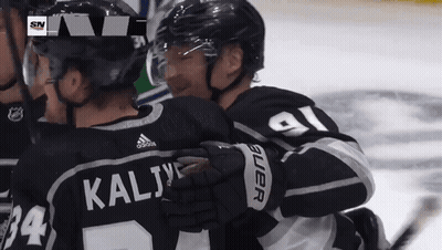 Hockey Player Kalij Hugging Another Player GIF