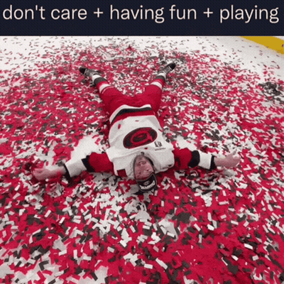 Hockey Player Laying On Ground Surrounded By Confetti Saying Don't Care Having Fun Playing GIF