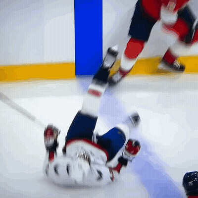 Hockey Player Laying On Ice With Number 5 GIF