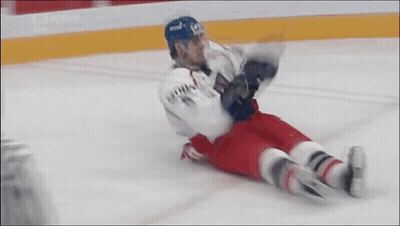 Hockey Player Lying On Ice In Blue Helmet GIF
