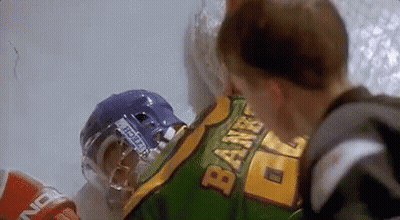 Hockey Player Lying On Ice With Helmet Next To Boy GIF