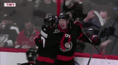 Hockey Player Morris Hugging Another Player On Ice GIF