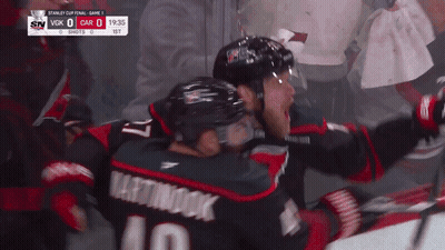 Hockey Player Number 10 Hugging Another Player GIF