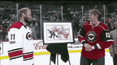 Hockey Player Number 12 Holding Framed Picture GIF