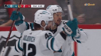 Hockey Player Number 12 Hugging Another Player GIF