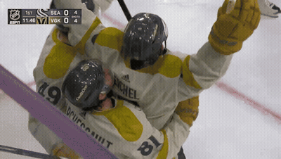 Hockey Player Number 19 Hugging Another GIF