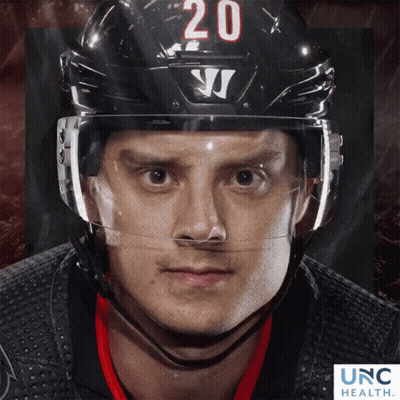Hockey Player Number 20 On Helmet Looking At Camera GIF