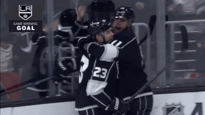 Hockey Player Number 23 Hugging Another Player GIF