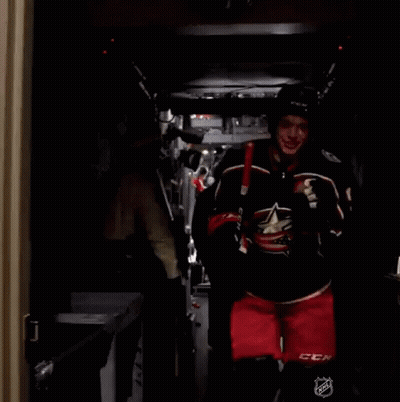 Hockey Player Number 3 Carrying Stick GIF