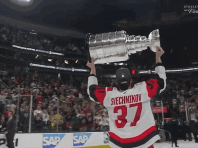 Hockey Player Number 37 Holding Trophy GIF