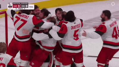 Hockey Player Number 5 Surrounded By Players GIF