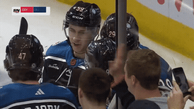 Hockey Player Number 59 Surrounded By Teammates GIF
