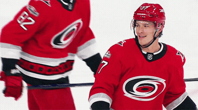 Hockey Player Number 7 Standing Next To Another GIF