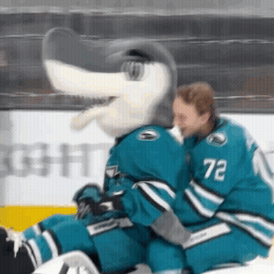 Hockey Player Number 72 Hugs Mascot GIF