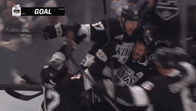 Hockey Player Number 84 Surrounded By Teammates GIF