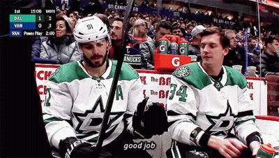Hockey Player Number 91 Sitting Next To Another Player GIF