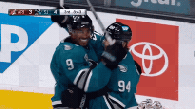 Hockey Player Number 94 Hugging Another GIF