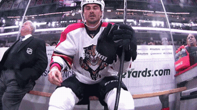 Hockey Player Sitting On Bench In Front Of Yards.com Sign GIF