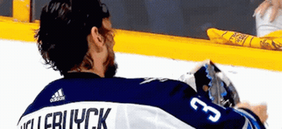 Hockey Player Sitting On Ice In Blue And White Jersey GIF