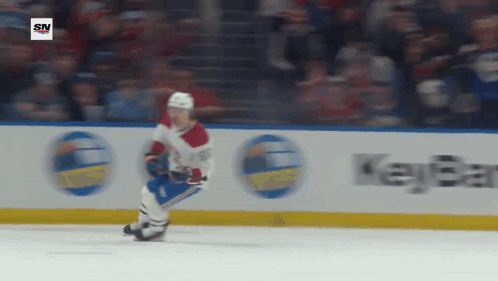 Hockey Player Skating In Front Of Key Bank Sign GIF