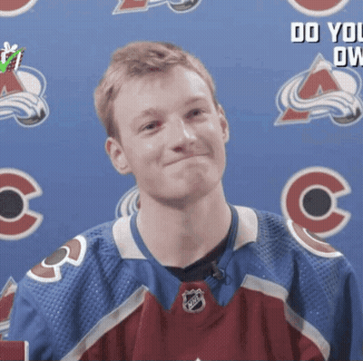 Hockey Player Smiling In Front Of Banner GIF