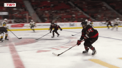 Hockey Player With Number 28 Holding Puck GIF
