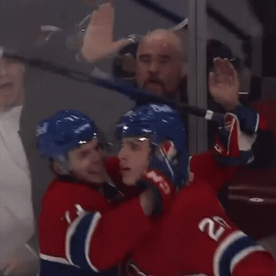 Hockey Players Celebrating Goal With Puck GIF