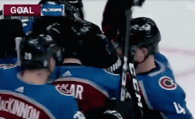 Hockey Players Huddled Near Goal GIF