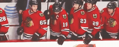 Hockey Players in Red Jerseys Number 65