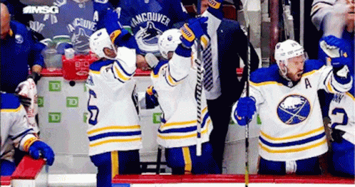 Hockey Players Sitting On Bench GIF