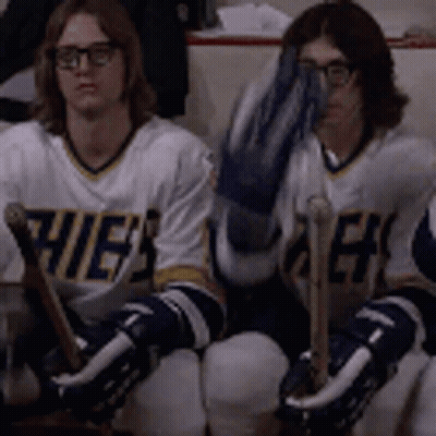 Hockey Players Sitting On Bench One Covering Face GIF