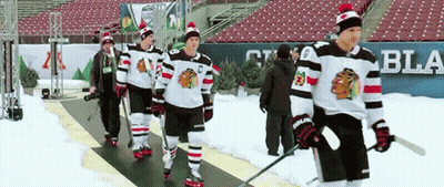 Hockey Players Walking Down Snowy Rink GIF