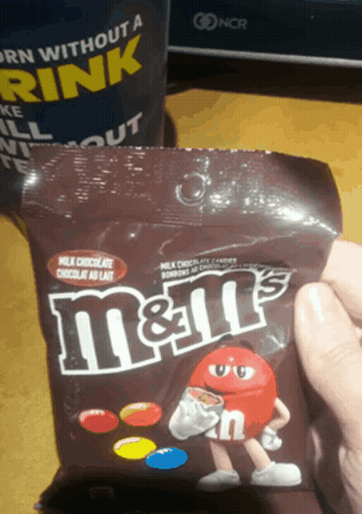 Holding Bag Of M&M's In Front Of Cup Saying Born Without A Drink GIF