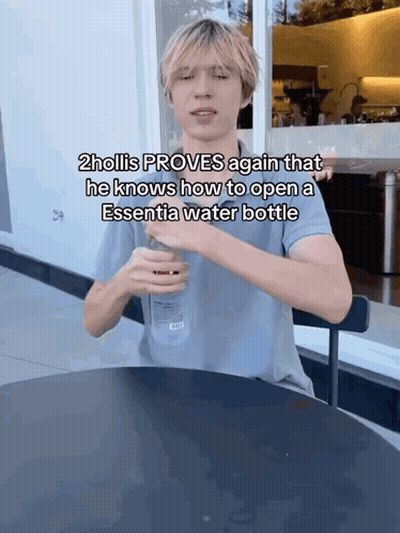 Hollis Opening Essentia Water Bottle At Table GIF