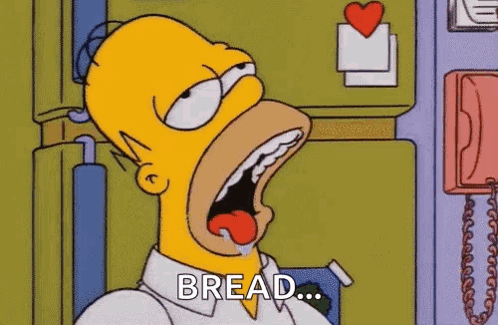 Homer Simpson From The Simpsons Is Eating Bread With His Mouth Wide Open . GIF