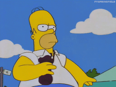 Homer Simpson From The Simpsons Is Holding A Spoon In His Right Hand GIF
