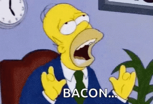 Homer Simpson From The Simpsons Is Sitting In A Chair With His Mouth Open And Screaming . GIF