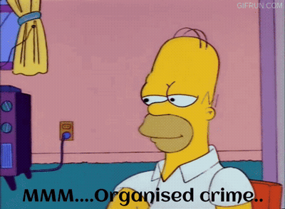 Homer Simpson From The Simpsons Is Sitting In Front Of A Tv And Says " Organised Crime " GIF