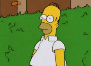 Homer Simpson From The Simpsons Is Standing In A Grassy Area GIF