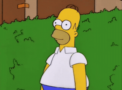 Homer Simpson From The Simpsons Is Standing In The Grass GIF
