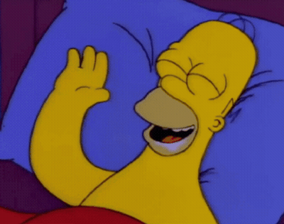 Homer Simpson Is Laying In Bed With His Eyes Closed And His Hand Up GIF