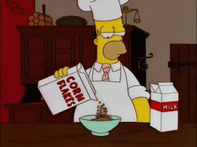 Homer Simpson Is Pouring Corn Flakes Into A Bowl While Wearing A Chef 'S Hat . GIF