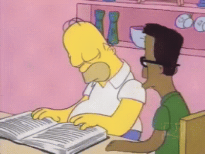 Homer Simpson Is Reading A Book While Sitting At A Table With A Man . GIF